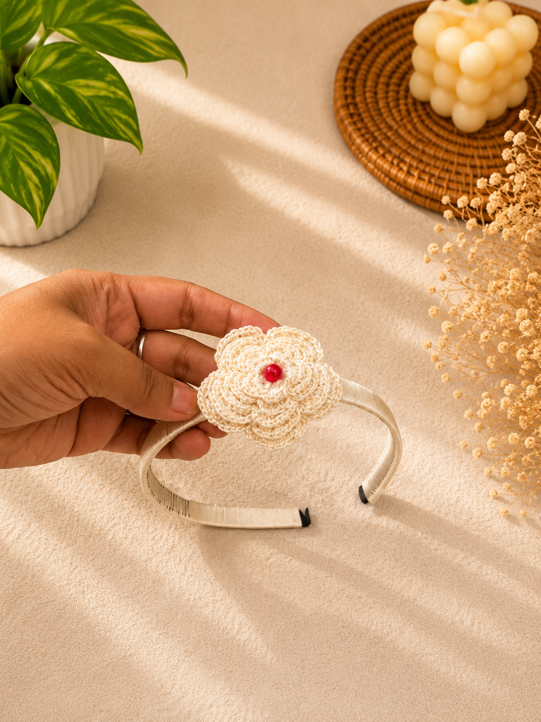 Ivory Bloom crochet flower headband with decorative center and satin-wrapped band by The Hook Project.