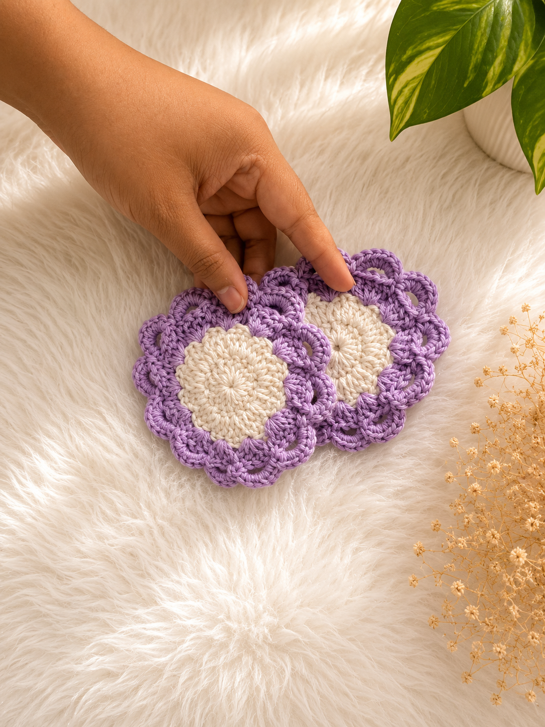 Handmade lavender and ivory crochet coaster set featuring a floral center and scalloped lace border crafted from premium cotton yarn by The Hook Project.