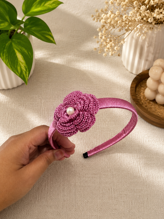 Rose Pink Bloom crochet flower headband with pearl center and satin-wrapped band by The Hook Project.
