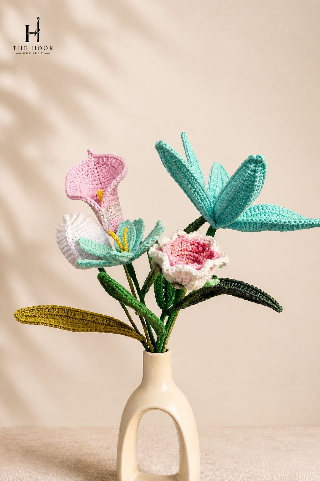 Collection of handcrafted crochet flowers including lilies, daisies, and decorative floral stems arranged for home décor and gifting