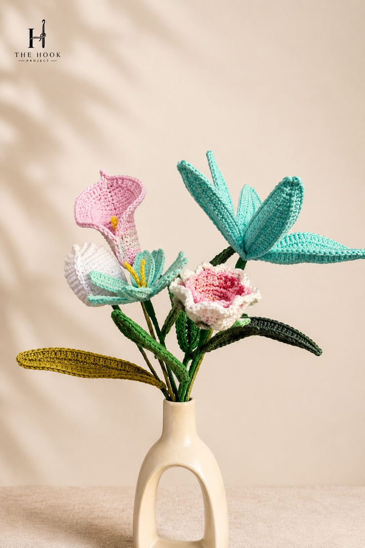 Collection of handcrafted crochet flowers including lilies, daisies, and decorative floral stems arranged for home décor and gifting