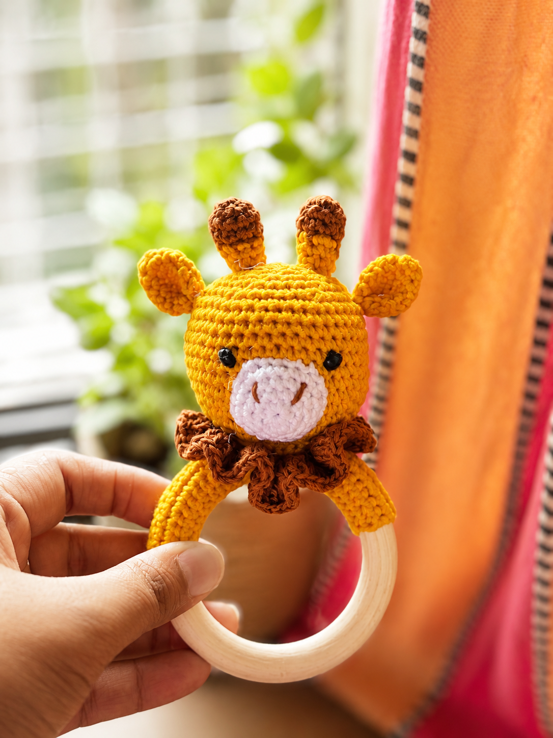 Handcrafted crochet giraffe baby rattle with wooden ring by The Hook Project