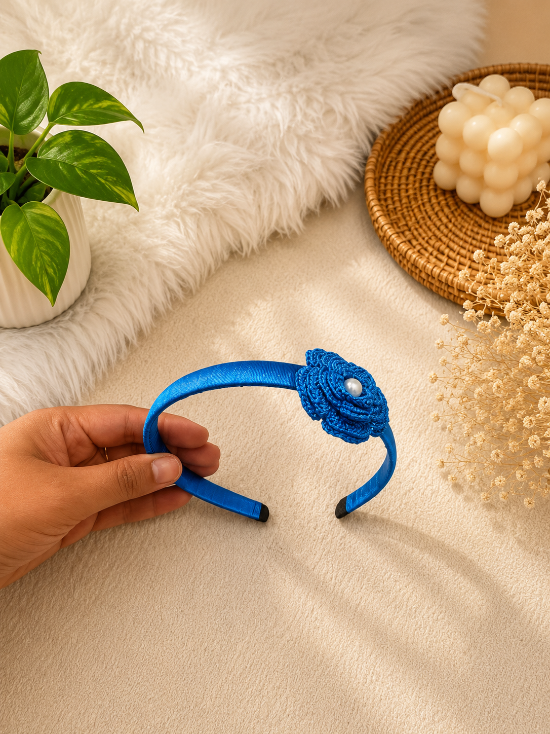 Sapphire Bloom crochet flower headband with pearl center and satin-wrapped band by The Hook Project.