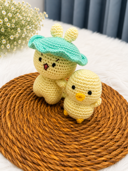 Mama & Peep Crochet Chick Duo – handmade mother and daughter chick plush set crafted from soft cotton yarn, displayed on a woven mat by The Hook Project.