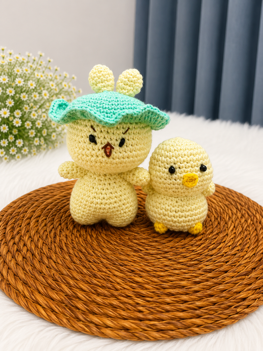 Mama & Peep Crochet Chick Duo – handmade mother and daughter chick plush set crafted from soft cotton yarn, displayed on a woven mat by The Hook Project.