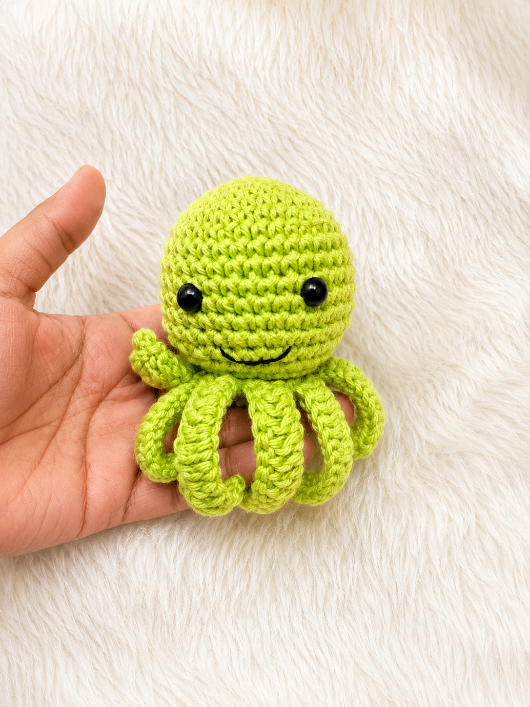 Handmade crochet octopus keychain available in multiple colors and sizes, featuring a smiling amigurumi octopus with curled tentacles and metal keyring by The Hook Project.