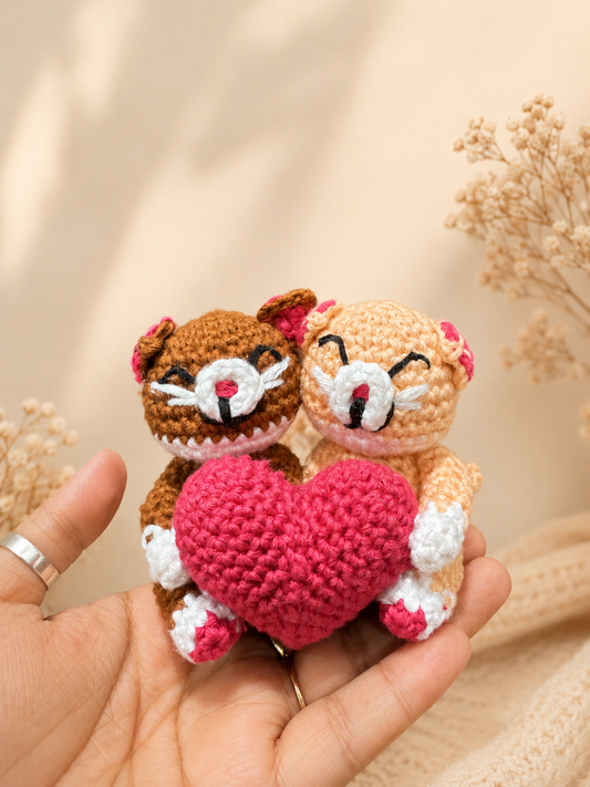 Handcrafted crochet cat couple holding a pink heart, handmade plush keepsake by The Hook Project