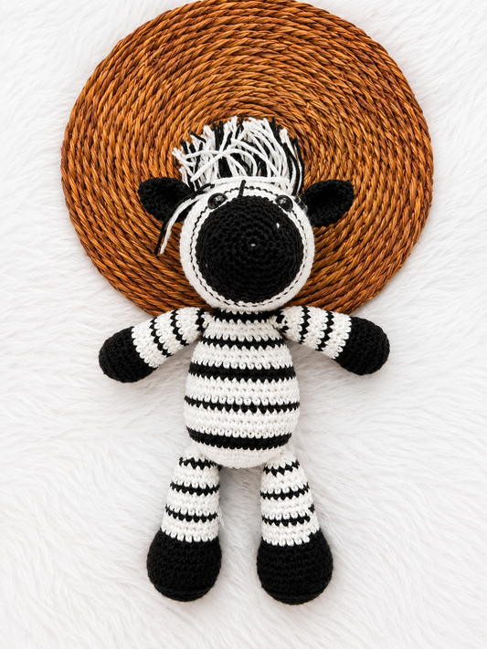 Handmade black and white crochet zebra amigurumi plush toy with yarn mane and striped body, crafted from premium cotton yarn.