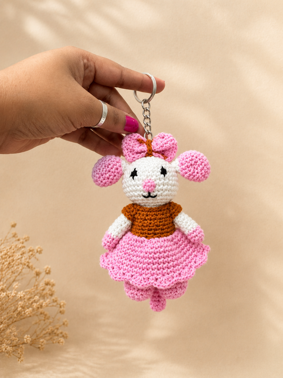 Handcrafted crochet mouse keychain with pink bow and skirt, handmade cotton yarn accessory by The Hook Project