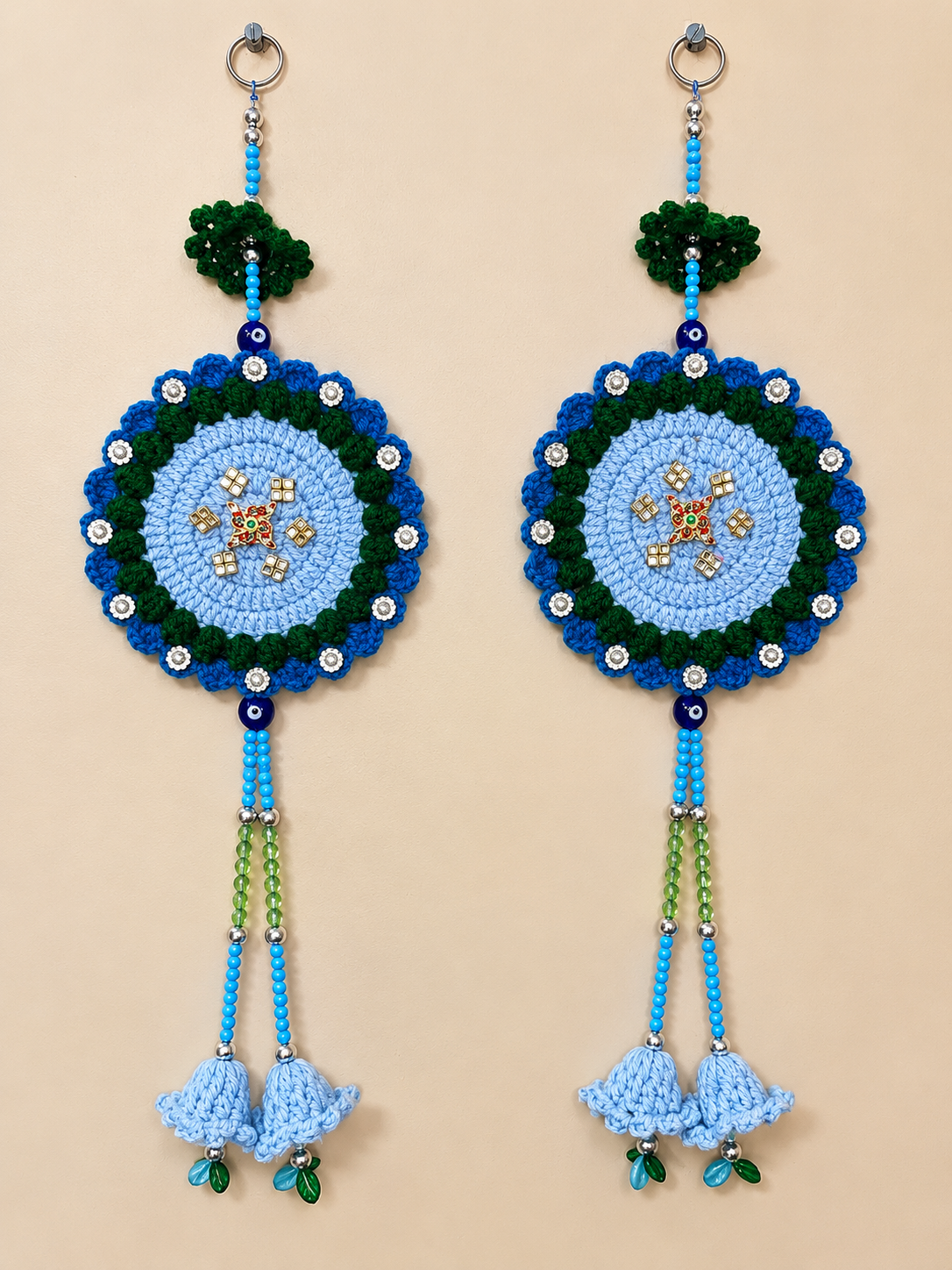 Shubh Sathiya crochet wall hanging set of 2 in light blue, royal blue and green with central Sathiya embellishments, decorative beads and crochet bell tassels.