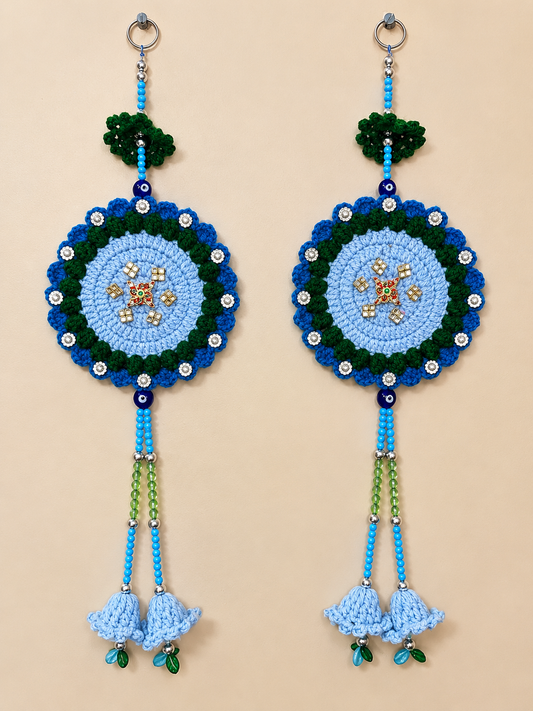 Shubh Sathiya crochet wall hanging set of 2 in light blue, royal blue and green with central Sathiya embellishments, decorative beads and crochet bell tassels.