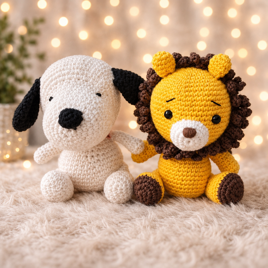 Handmade crochet lion and puppy toy set sitting together on a soft cream background with warm decorative lights.