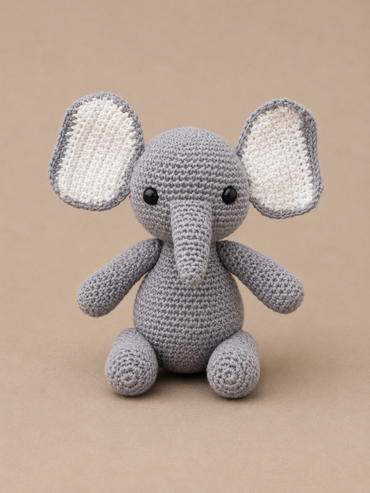 Handmade gray crochet elephant amigurumi plush toy with oversized ears and a soft trunk, crafted from premium cotton yarn and designed for gifting, nursery decor, and crochet collections.