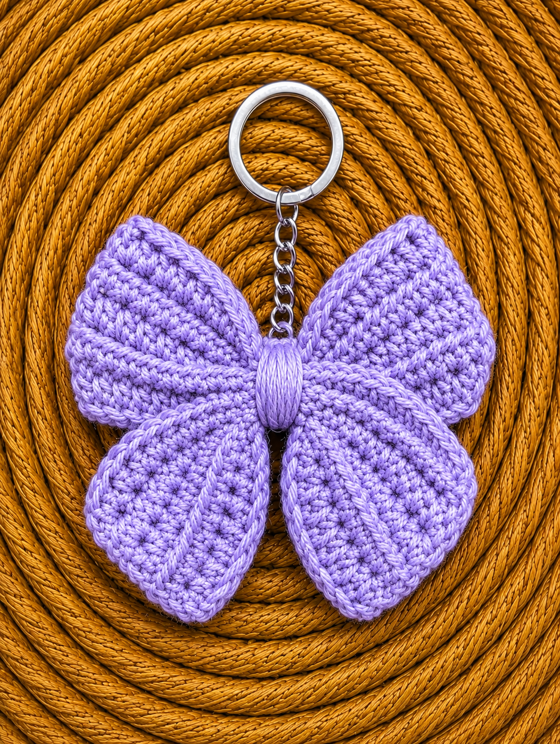 Elegant lavender crochet bow keychain handcrafted from cotton yarn with metal keyring, ideal for gifting and everyday use.