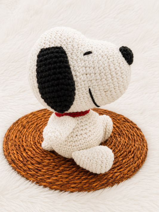 Handmade crochet Snoopy-inspired plush toy crafted with premium white cotton yarn, black ears, and a red collar.