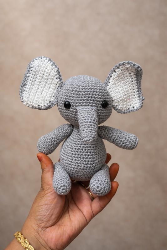 Handmade gray crochet elephant amigurumi plush toy with oversized ears and a soft trunk, crafted from premium cotton yarn and designed for gifting, nursery decor, and crochet collections.